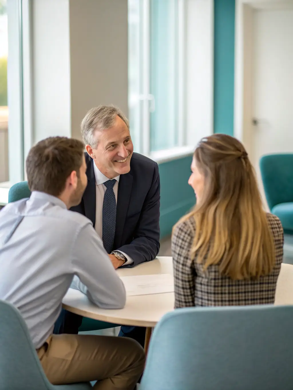 A professional mediator facilitating a discussion between two parties in a modern office setting, emphasizing collaboration and problem-solving.